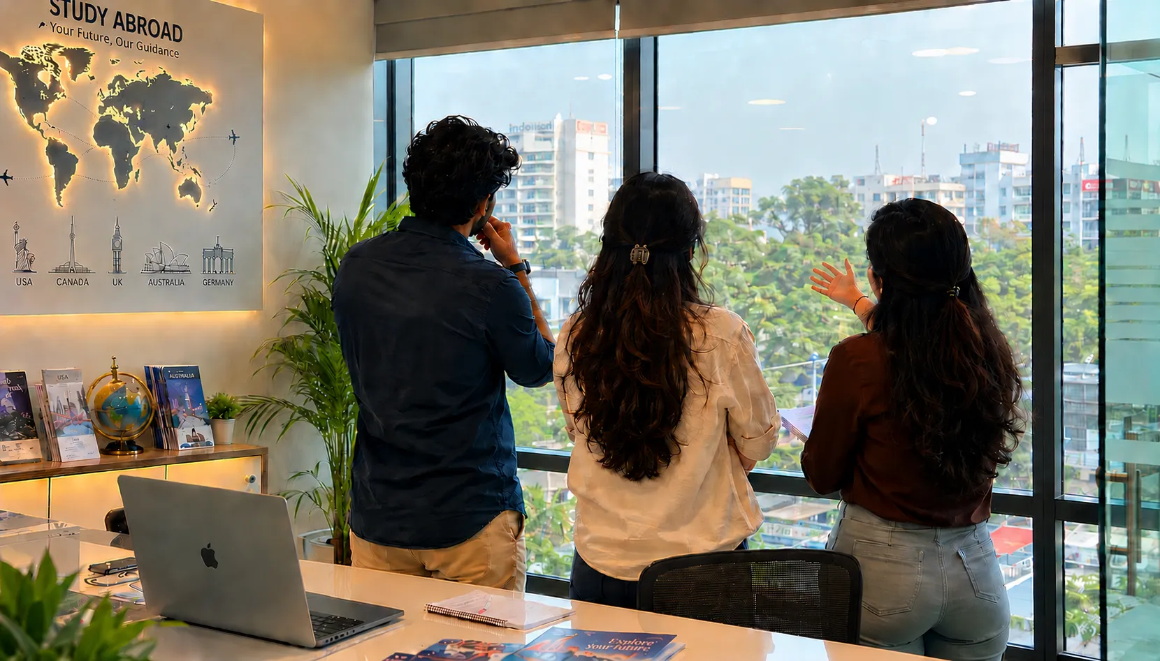 The Abroad counselling team reviewing study destinations by the office window in Hyderabad
